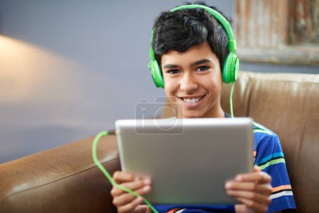 Photo for Tablet, portrait or boy with headphones on sofa for gaming, search or google it sign up at home. Digital, search and face of happy kid with app for elearning, streaming or educational, video or film. - Royalty Free Image