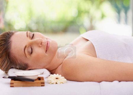 Photo for Calm woman, sleeping and relaxing with towel for spa, zen or treatment on massage table, hotel or outdoor resort. Face of young female person asleep for peace, relaxation or accommodation in wellness. - Royalty Free Image