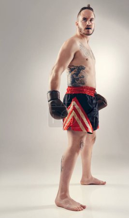 Photo for Sports, man and body of boxer for fitness in studio isolated on a white background mockup space. Serious fighter, athlete and person in gloves for exercise, workout or thinking of training for health. - Royalty Free Image