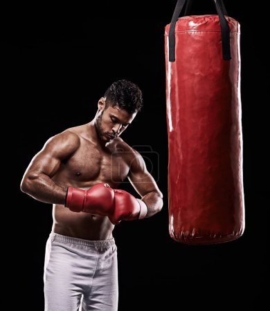 Photo for Hands, boxing bag and gloves for male boxer, studio and athlete on black background. Dark, training and combat sports or MMA for man model, workout, muscle and impact activity for martial arts. - Royalty Free Image