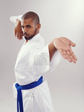Photo for Studio, karate and black man with technique for martial arts with hand strike, shuto uchi and training. White background, adult and African male person with healthy body for movement and disciple. - Royalty Free Image
