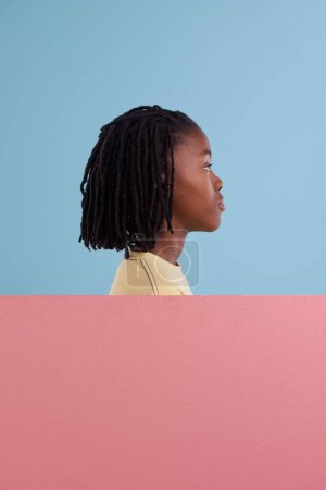Photo for Banner, mockup and African boy child thinking in studio with questions, solution or why on blue background. Poster, space and profile of teen model with billboard for faq, problem solving or idea. - Royalty Free Image
