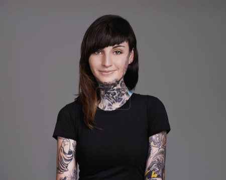 Photo for Happy woman, portrait and tattoo with fashion for facial treatment, style or body art on a gray studio background. Female person, young model or smile for design, creativity or cool beauty artist. - Royalty Free Image
