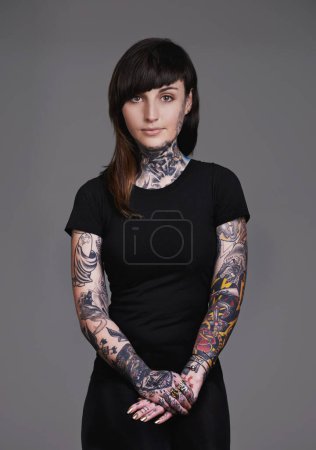 Photo for Woman, portrait and tattoo with fashion or sleeves for facial treatment, style or body art on a gray studio background. Female person, young model or smile in design, creativity or cool beauty artist. - Royalty Free Image