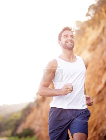 Photo for Man, runner and active for outdoor workout, sports and nature for cardio or training for marathon. Male person, happy and fitness on mountain for performance challenge, athlete and exercise for race. - Royalty Free Image