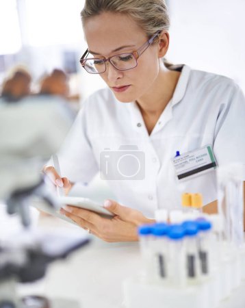 Photo for Reading, research and woman with tablet in medical laboratory with development in biotechnology. Scientist, typing or check results online of pharmaceutical report or review of innovation in science. - Royalty Free Image
