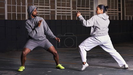 Photo for Martial arts, fight and man with woman, fitness and wellness with cardio or exercise with energy. Challenge, coach or athlete with sports or workout with competition or fighter with skill or training. - Royalty Free Image