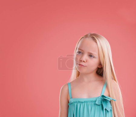 Photo for Girl, kid and thinking on growth in studio, child development and ideas on pink background. Female person, planning and confidence for childhood on mockup space, contemplating and innocent ponder. - Royalty Free Image