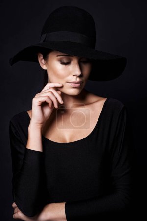 Photo for Woman, fashion and hat in studio with beauty, mob or classic gangster style on black background. Confidence, stylish with accessory and skin glow, fedora and vintage trend with designer clothes. - Royalty Free Image