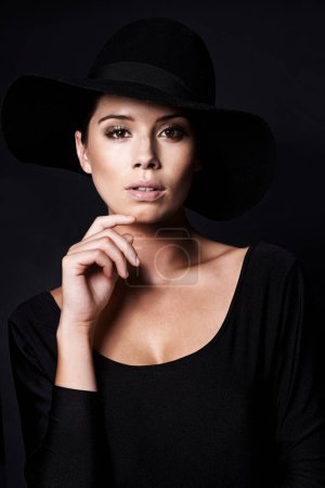 Photo for Woman, fashion and hat in portrait with beauty, mob or classic gangster style on black background. Confidence, stylish with accessory and skin glow, fedora for vintage trend and designer in studio. - Royalty Free Image
