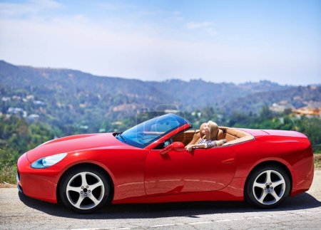 Photo for Woman, relax and summer in sports car for road trip or adventure on vacation or holiday in Beverly Hills. Luxury vehicle for speed on highway, transport and drive on mountain for journey or freedom - Royalty Free Image