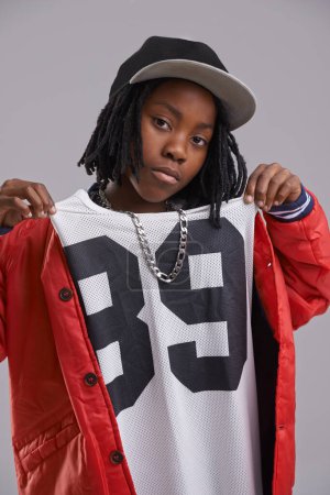 Photo for Studio, portrait and boy with hip hop for fashion with clothes for aesthetic of culture for youth. Grey background, teenager and child with swag, cool and kid with trendy style of confidence. - Royalty Free Image