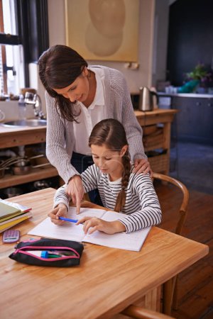Photo for Studying, mother and daughter for writing with help, advice and check for homework with education. Mom, girl and notebook with drawing, notes and development with learning in kitchen at family house. - Royalty Free Image