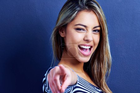 Photo for Studio, portrait and woman pointing with finger, excited and happiness on face of female person. Blue background, hands and deal for fashion, aesthetic and smile for clothes, girl with choice. - Royalty Free Image