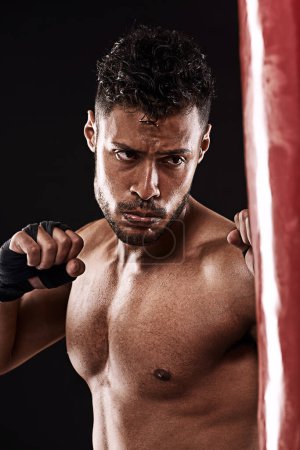 Photo for Boxing, man and training in studio with fitness for workout, exercise or competition fight with punching bag. Athlete, boxer and confidence for martial arts with energy or topless on black background. - Royalty Free Image