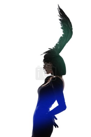 Photo for Feather, fashion and unique style woman in a studio with head piece, bird hat and art with gothic creativity. Crow, silhouette and shadow with fantasy and with goth trend and white background. - Royalty Free Image