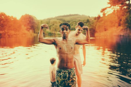 Photo for Portrait, teenager and flex with nature, lake and friends with happiness and bonding together. People, outdoor and boys in water, environment and chilling with vacation and holiday with adventure. - Royalty Free Image