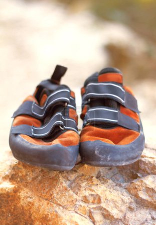 Photo for Rock climbing, shoes and mountain sport with rubber soles to support performance and precision for feet safety. Nature sports, equipment or edging for smearing on rocky surface or balance for agility. - Royalty Free Image