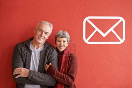 Photo for Happy, portrait and senior couple in studio with notification icon for message or email to connect together. Man, woman and red background with popup for contact or social media and communication - Royalty Free Image