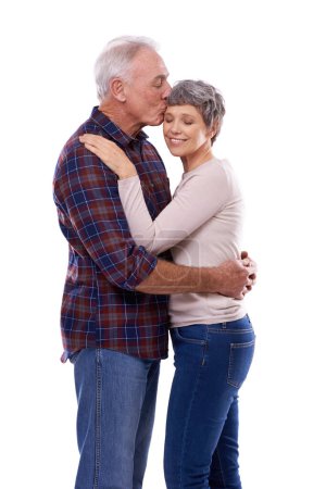Photo for Kiss, hug and senior couple on a white background for bonding, affection and loving relationship. Marriage, happy and mature man and woman embrace for commitment, love and care in studio together. - Royalty Free Image
