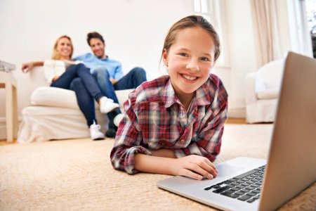 Photo for Parents, portrait or girl with laptop for elearning or studying for remote education on carpet at home. Relax, father or mother with family blur, smile or happy child streaming video, film or movies. - Royalty Free Image