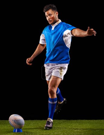 Photo for Kick, ball and portrait of man for rugby sport or training for workout, fitness and skill. Person or player on grass and athlete practice for goal or football game or match on black background - Royalty Free Image