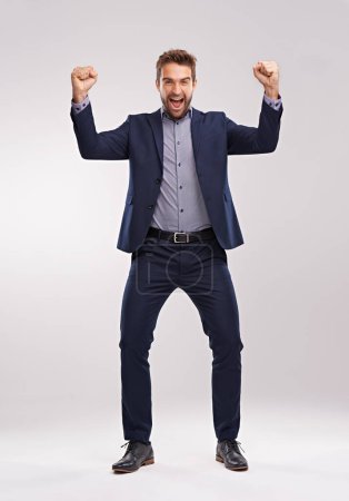 Photo for Excited, portrait or businessman with success and smile for winning a prize in studio on white background. Cheering, sales offer or happy salesman with motivation, news announcement or achievement. - Royalty Free Image
