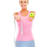 Woman, portrait and studio with apple and measuring tape for healthy or slim body, dietitian or nutritionist for fit figure. Person, happy and fruit for diet and exercise for wellness or self care.