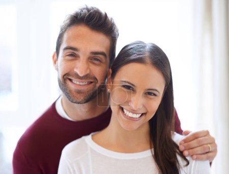 Photo for Portrait, happy couple and hug in a house with love, trust and security, support or bonding at home together. Marriage, commitment or face of people in a living room with romance, care or gratitude. - Royalty Free Image