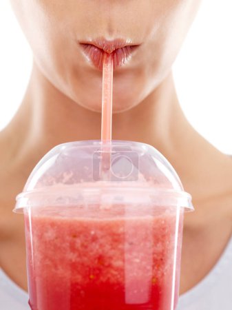 Photo for Lips, straw and drinking a smoothie in studio, nutrition and wellness with juice on white background. Person, closeup and milkshake for weight loss or detox, minerals and vegetarian fiber or organic. - Royalty Free Image
