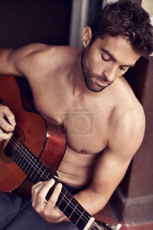 Photo for Guitar, play or man in home for music, performance or entertainment with sound, rhythm or talent. Learning solo, topless artist or creative male musician with an instrument for practice routine alone. - Royalty Free Image