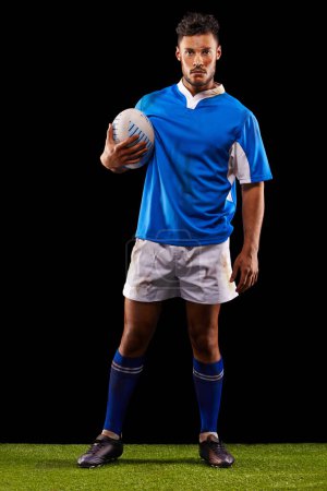 Photo for Rugby, fitness and portrait of man in studio for game, competition and sportswear in dark background. Ball, exercise and young male athlete with confidence for professional sport, workout or training. - Royalty Free Image
