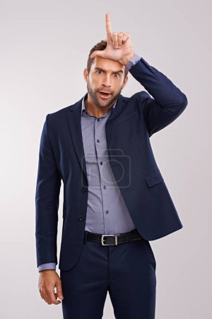 Photo for Portrait, loser gesture and man with business, fail and mistake on a white studio background. Person, employee or entrepreneur with L symbol, emoji or sign with icon or silly with negative expression. - Royalty Free Image