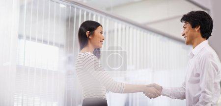 Photo for Happy, business people and handshake with team for meeting, agreement or deal together at the office. Young asian man and woman shaking hands for b2b, greeting or partnership at the workplace. - Royalty Free Image