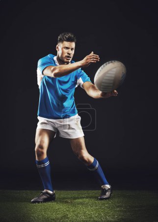 Photo for Night, man and pass ball for rugby sports goal or training for skill for football game or match, professional and athlete. Male person or player, action and energy for competition and fitness workout. - Royalty Free Image