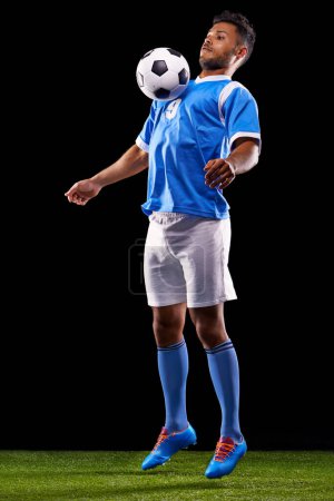 Photo for Man, soccer ball and play for sport, fitness and game for active and sportswear on grass or field. Arab person, sportsman or athlete and practice for strong and competitive on dark background. - Royalty Free Image