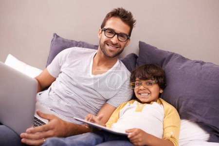 Photo for Portrait, father and child with laptop or tablet in bed for connectivity, technology and streaming online for news. Family, man and young boy at home with computer, movie or cartoon for bonding. - Royalty Free Image
