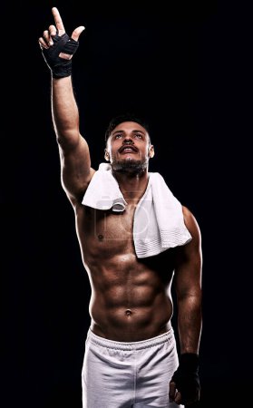 Photo for Man, boxer and hand in studio for faith, fitness and pointing up for training on black background. Person, athlete and strong muscles for workout or exercise, religion and battle or competition. - Royalty Free Image