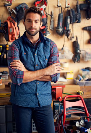 Photo for Carpenter, tools and portrait of man with arms crossed for home development, maintenance and renovation in workshop. Confident, male person and contractor for construction, equipment and repair work. - Royalty Free Image