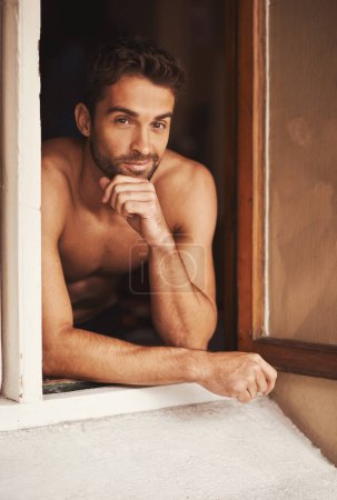 Photo for Portrait, window and shirtless man in home with confidence, relax and thinking in apartment alone in the morning. Face, body and male person with muscle, strong abs and health in house in Portugal. - Royalty Free Image