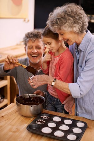 Photo for Help, grandparents and baking with girl, home and hobby with happiness and bonding together with recipe. Family, grandchild and senior man with old woman and activity with utensils, food and teaching. - Royalty Free Image