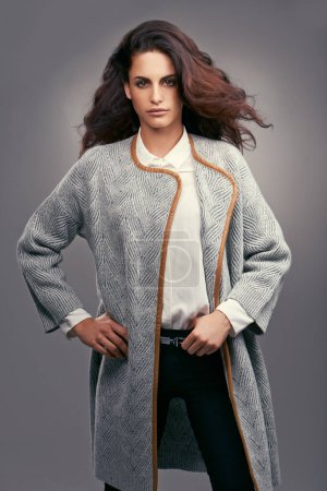 Photo for Woman, portrait and elegant fashion in studio with confidence, classy style and trendy aesthetic with coat. Model, person and face with attitude in stylish clothes and hairstyle on grey background. - Royalty Free Image
