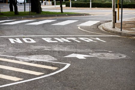 Photo for Road marking, no entry and warning with text, arrow and error for direction with paint on asphalt in city. Ground, street and mistake with language, funny typo and comic joke with symbol in Cape Town. - Royalty Free Image