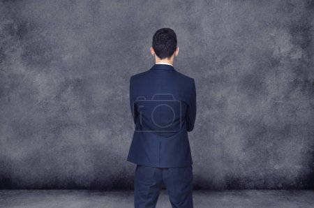 Photo for Businessman, thinking and decision with choice for ideas, selection or pick on a gray studio background. Rear view of man or employee in wonder, thought or choose for career ambition on mockup space. - Royalty Free Image