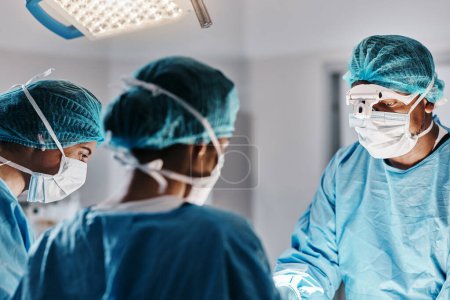 Photo for Doctor, surgery and operating room with face mask for medical emergency, operation or hospital. People, teamwork and healthcare for accident wellness for healing procedure, collaboration or helping. - Royalty Free Image