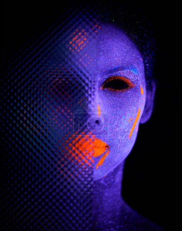 Photo for Face, neon and creepy paint for creative, art and glitter for unique psychedelic glow. Person, science fiction or color for pixel, particle and dissolving uv illusion for mystical fluorescent trance. - Royalty Free Image
