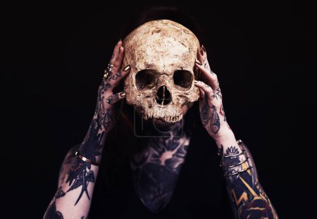 Photo for Skull, art and woman with tattoo in studio for dark magic, horror or scary aesthetic with object. Creative nightmare, halloween culture and unique person in surreal bone portrait on black background. - Royalty Free Image