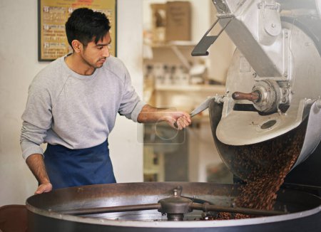 Coffee beans, small business and man with machine for roasting with blending, production and quality control. Entrepreneur, barista or roaster at cafe, sustainable startup shop and espresso process.
