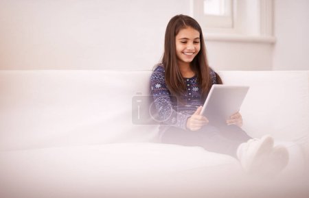 Photo for Space, home or girl with tablet for elearning, playing games or streaming videos on a movie subscription. Education, online or happy child with technology to download on app or reading ebook on couch. - Royalty Free Image