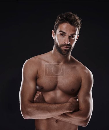 Photo for Portrait, muscle and body of confident man in studio isolated on a black background for wellness, sexy or six pack. Model, face and topless person with arms crossed for health and strong abs in Spain. - Royalty Free Image